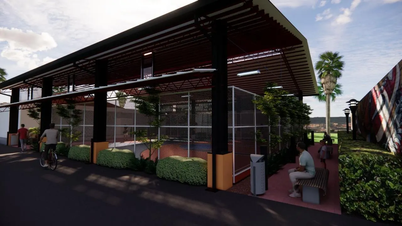 Covered sports court under a red steel roof with netted sides and planting (3)