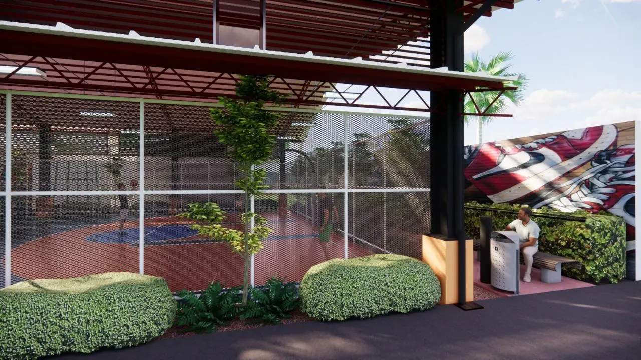 Covered sports court under a red steel roof with netted sides and planting (4)